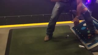 Guy golf between legs backwards