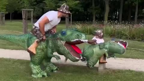 Dinosaur funny costume kid and father playing in park. amusement entertaining activity