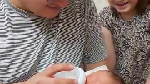 Dad feeds newborn baby formula for the first time