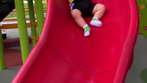 Baby Slips Slowly Down Slide