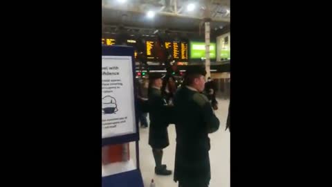Pipe down! Bagpipe band plays at London's Charing Cross station
