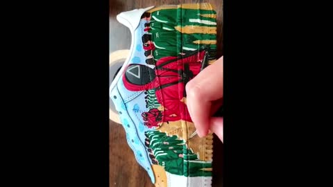 Shoe artist paints custom Nike Air Force One's with Squid Game theme