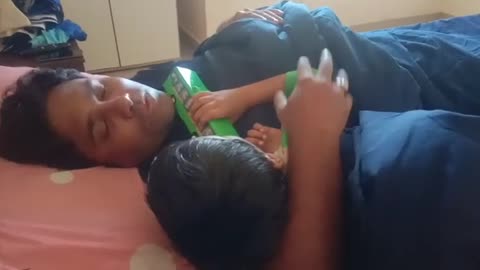 Indian father telling random story to cute baby to sleep