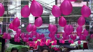 Yangon residents hang red balloons to support NLD