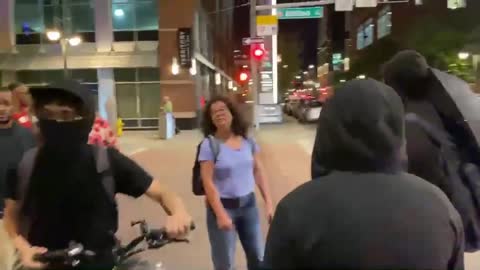 woman gets out of her car to confront antifa who threw a projectile at the Hyatt Regency in Denver.