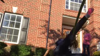 Girl stands on yellow soccer balls and falls