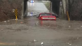 Truck Tries to Cross Flooded Underpass