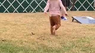Little Girls Spins and Falls Down in Grass