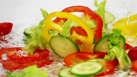 Slices of vegetables falling into the water