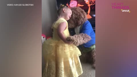 Little girl and her dog dance as Beauty and the Beast