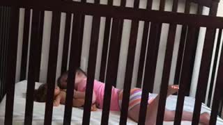 Little Girl Talking to Doll in Crib