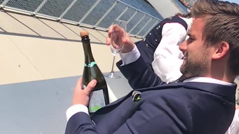 Guy tries to open champagne bottle with glass sabrage