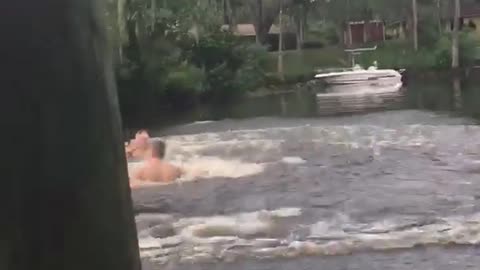 Guy jumps out of tree into water lake river bridge