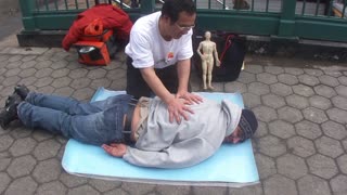 Luodong Massages Man In Hoodie On Sidewalk