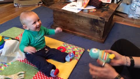 Baby finds game of catch absolutely hysterical