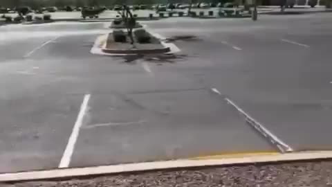 Man measure ma EMF radiation at empty electric charging station