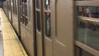 Brown subway driving off leaving platform