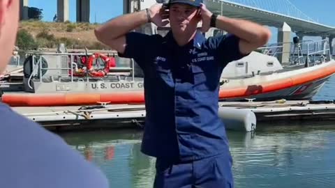 Coast Guard Officers dodging Enlisted cleaning the small boats.