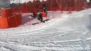 Skier does a trick off a ramp and flies into a net