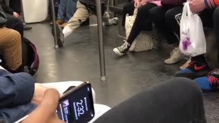 Man subway sunglasses stretching splits between pole and door