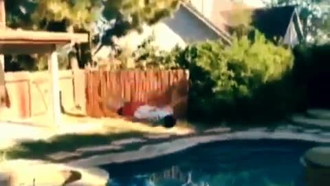Guy jumps from roof of house blly flop into pool