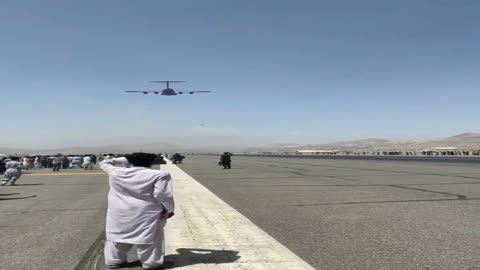 People seen holding on to a plane as it prepares to take off from Kabul Airport