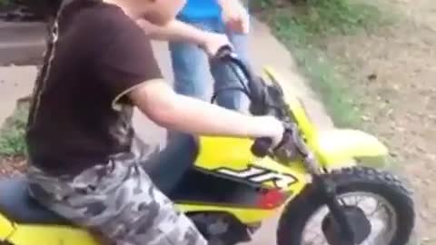 Kid Falls terribltly while trying to drive his brothers motorcycle