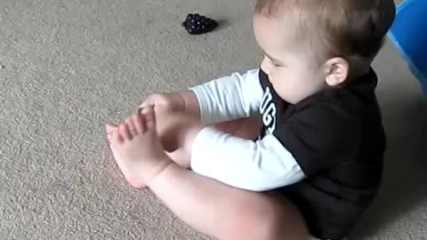 Frustrated Baby Can't Put His Sock On