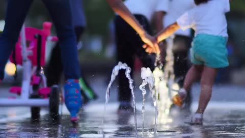 children playing with a dancing fountain