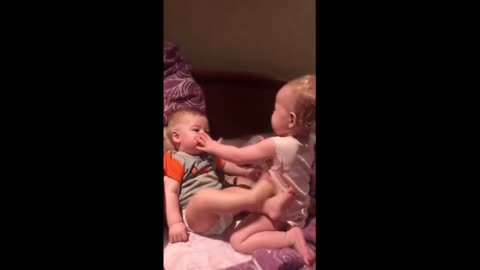 Toddler hilariously attempts to bottle feed baby