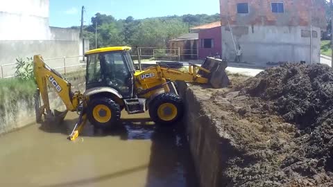 Retroescavadeira JCBB 4CX descendo no córrego(JCBB 4CX backhoe loader going down stream