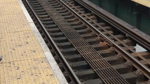 Man walks across train tracks