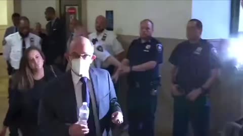 Who is this masked man coming out of the courtroom