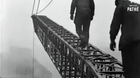 Engineers walking a crane in London in 1927