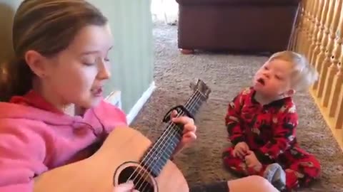 Watch this sister sing "You are my sunshine"