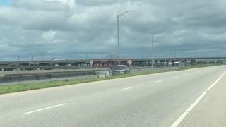 Police Car Drives Through Flooded Water In Mobile Alabama and Tractor Clears Flooded Road In Mobile.