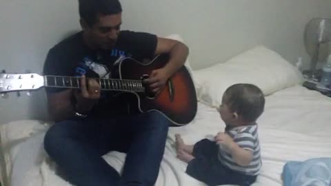 Baby laughs hysterically at guitar performance