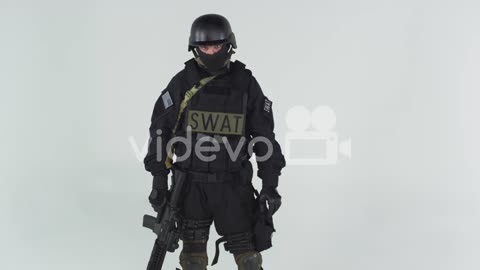 Swat soldier wearing his gear and carrying a weapon