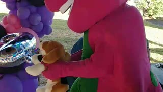 Purple dinosaur sings and dances to bingo at a birthday party at city ranch in Houston Texas