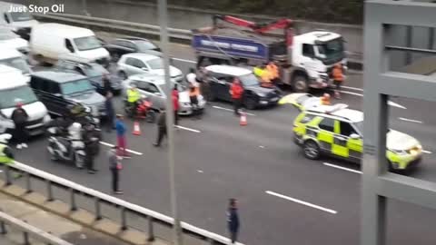 Just Stop Oil: Drivers get out of vehicles in standstill M25 traffic near Heathrow