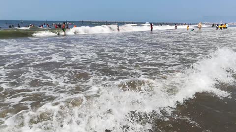 Boys Facing Big Waves In Ras El Bar Beach