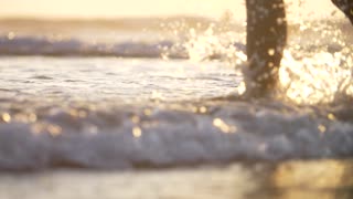 Close-Up of Legs Walking in the Surf