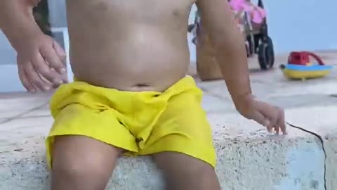 Funny baby reaction on beach