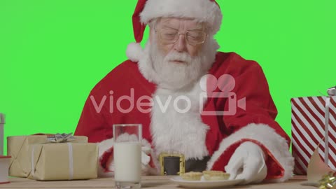 Portrait Shot of Santa Pulling a Plate of Mince Pies to Him