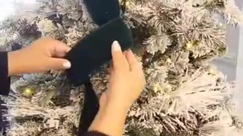 Golden Retriever "helps" decorate Christmas tree