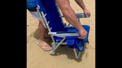 Folding beach chair: 5 positions, towel bar, cooler & storage pouches, cup & phone holders.