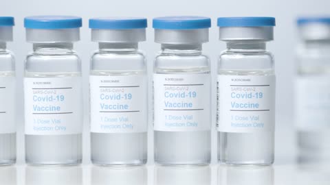 Sliding Close Up Shot of Four Vials Containing Covid 19 Vaccine