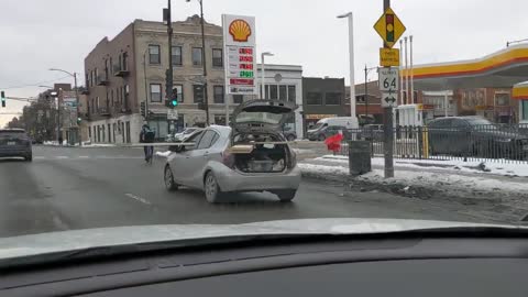 Subcompact Car Driving With Long Wooden Boards Sticking Far Out