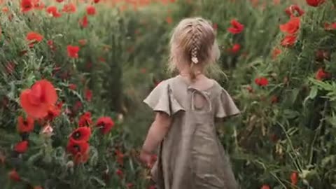 Girl Walking Between Red Poppy Flowers