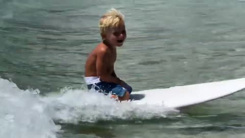 Baby Surfer surfing at Santinho Beach